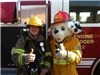 A Fireman Holding a Thumbs Up with Sparky