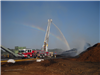 Fire Truck with Its Ladder Extended and a Rainbow in the Background