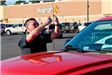 Police Officer Working on a Car Antenna in the Wal Mart Parking Lot