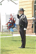 Officer Saluting in Front of a Memorial Wreath